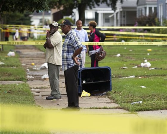 Residents look at damage to houses Friday in Milwaukee. Powerful thunderstorms caused widespread flooding in southern Wisconsin.